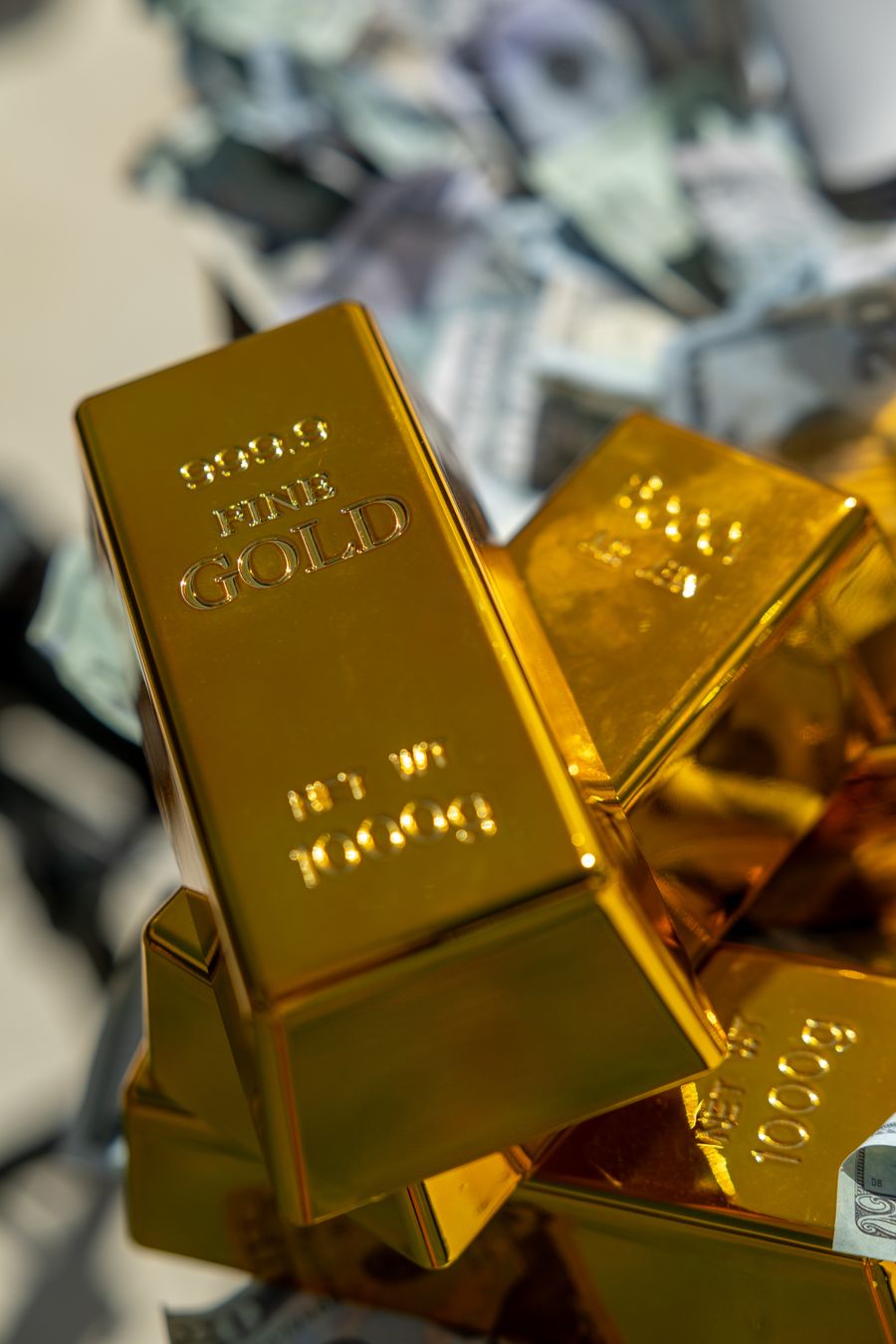 Gold bars stacked on cash — honest payouts for your precious metals